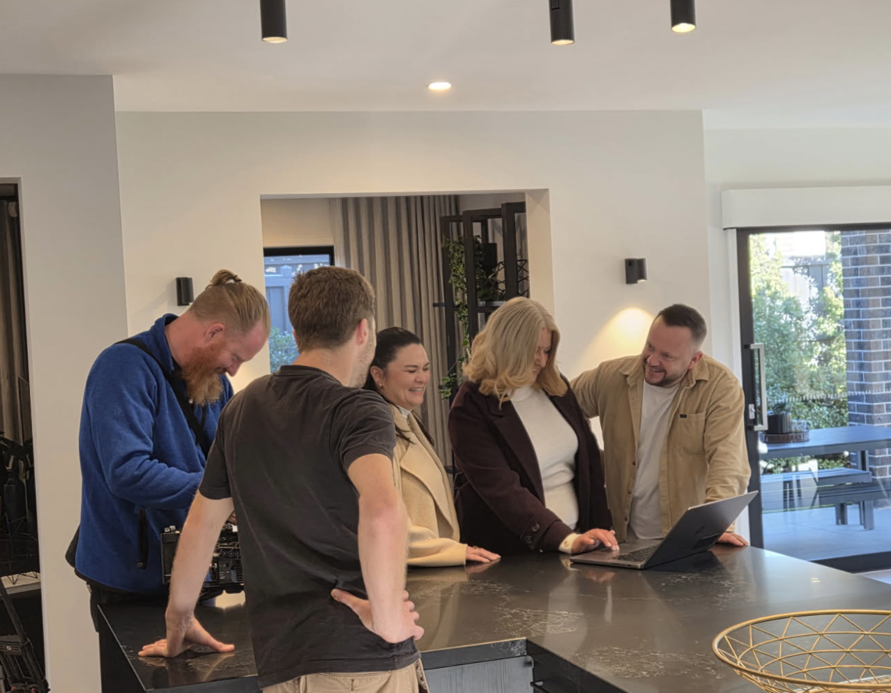 On Location: A beautifully styled display home set the scene, with the group gathered around the heart of the house.